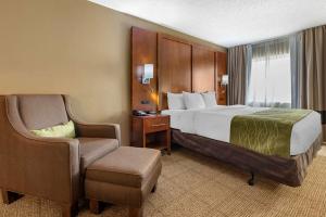 a hotel room with a bed and a chair at Comfort Inn Romeoville - Bolingbrook in Romeoville