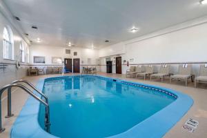 a large swimming pool in a room with chairs at Comfort Inn Romeoville - Bolingbrook in Romeoville