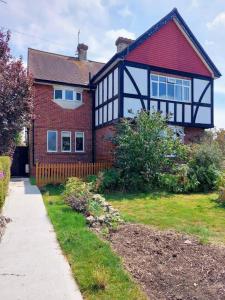 a brick house with a red and black roof at Inviting 1-Bed Apartment in Herne Bay in Herne Bay