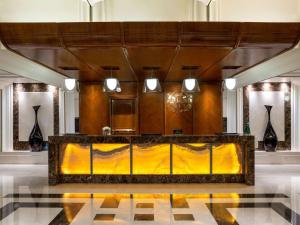 a lobby with a reception desk in a building at Swissotel Al Maqam Makkah in Mecca