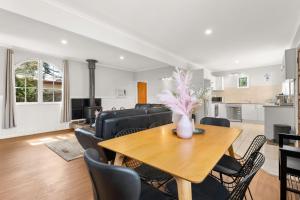 a dining room and living room with a table and chairs at Little Island Escape in Sunset Strip