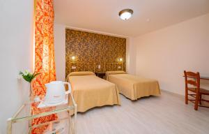 Postel nebo postele na pokoji v ubytování Hotel Manzanito