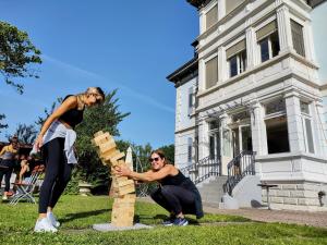 a man and a woman playing with blocks in front of a house at Adventure Hostel Interlaken in Interlaken