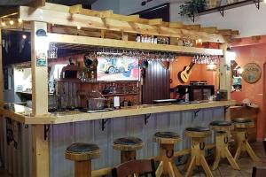 a bar with a bunch of stools in a room at Casa Lemus Inn in Raton