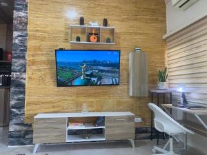 a living room with a television on a wall at Tayoon Host in Jerash