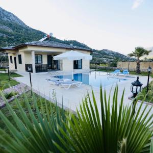 a villa with a swimming pool and a house at Villa Adrasan in Kumluca