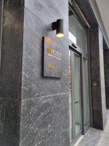 a sign on the side of a building at BB Hotels Smarthotel Duomo in Milan