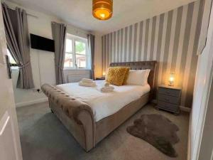 a bedroom with a large bed and a window at Coney Green Way - close to PRH in Wellington