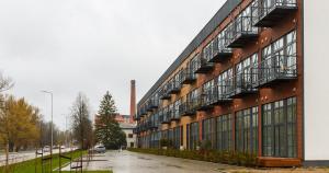 a large building with balconies on the side of it at Tamula Lake View Apartment in Võru