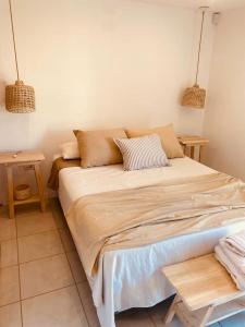 a large bed in a room with two pendant lights at Frontera Sur Apart in Miramar +31 photos