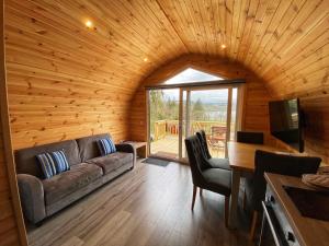 a living room with a couch and a table with chairs at Tarbert Holiday Park in Tarbert