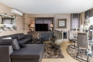 a living room with a couch and a chair at Mega suite on the sea in Perea