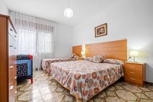 A bed or beds in a room at Villa Rosita