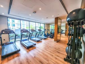 a gym with a row of treadmills at STAY BY LATINEM Luxury Studio Holiday Home G2-2507 near Burj Khalifa in Dubai