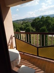 a balcony with a bed and a view of trees at Vila Borova Tara in Kremna +12 photos
