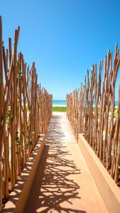 a row of wooden fences on the beach at Tulum Beach Resort Dakhla in Dakhla