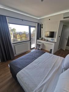 a bedroom with a large bed and a large window at Efzen hotel in Istanbul