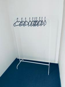 a rack of hangers in a corner of a room at Apartmány Bryksova in Prague