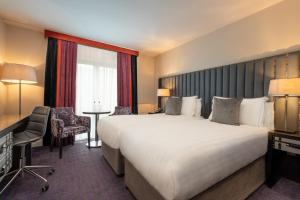 Voodi või voodid majutusasutuse The Trinity City Hotel toas