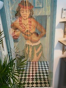 a shower curtain with a picture of a boy at Tropicana Guestroom 7 min walk from the beach in Dubai