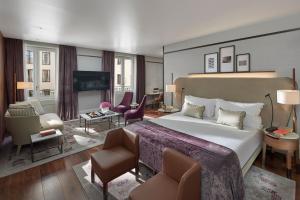 a bedroom with a large bed and a living room at Mandarin Oriental, Milan in Milan