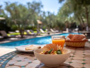 El Harkat的住宿－Villa Katia，一张桌子,上面放着一碗食物和一杯橙汁