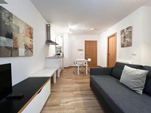 a living room with a couch and a table at Apartamentos Sierra Nevada 3000 in Sierra Nevada