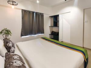 Cama ou camas em um quarto em Horizon Apartment 1BHK