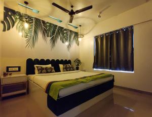 a bedroom with a bed with a ceiling fan at Horizon Apartment 1BHK in Pune