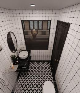 a bathroom with a toilet and a sink and a mirror at Đại Thủy Hotel CatBa in Cat Ba