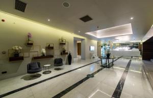 a lobby with two chairs and a hair salon at Batumi Inn Aparthotel With Sea View in Batumi