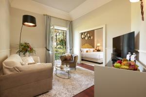 a living room with a couch and a television at Almar Giardino di Costanza Resort & Spa in Mazara del Vallo