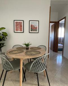a dining room table with chairs and a plant on it at Joli appartement au centre d'Oujda in Oujda