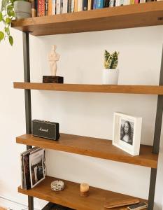 a shelf with books and other items on it at Nomas Skg Apartment by BiNoBi! in Thessaloniki +9 photos