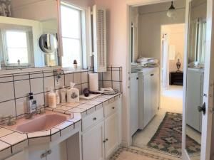a bathroom with a sink and a mirror at Fairy Hill Sanctuary in Monte Sereno +104 photos