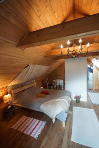 Cette chambre comprend un grand lit et un plafond en bois. dans l'établissement Stairs to Heaven, à Ventspils