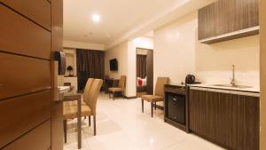 a kitchen and living room in a hotel room at RedDoorz Premium @ West Avenue Quezon City in Manila