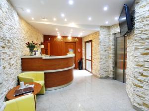 a hotel lobby with a bar and a tv at Aparthotel Adler in Krakow