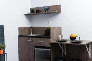 a kitchen with a sink and a table at Enattica Monastiraki Living in Athens