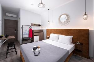 a bedroom with a bed with a table and a mirror at Enattica Monastiraki Living in Athens
