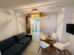 a living room with a couch and a table at Barbi Blue Apartments in Herceg-Novi