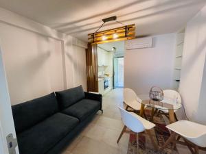 a living room with a black couch and a table at Barbi Blue Apartments in Herceg-Novi