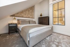 a bedroom with a large bed and a window at Artsy Exclusive Old Town Residence Gallery Walk in Vilnius