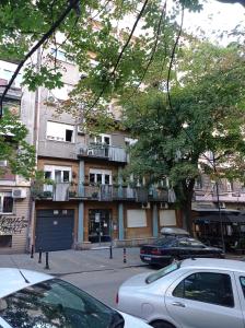 an apartment building with cars parked in front of it at KaLuMa in Belgrade