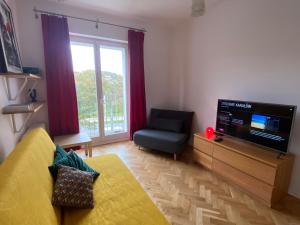 Televízia a/alebo spoločenská miestnosť v ubytovaní Kawalerka w centrum Gdyni z osobną kuchnią, 15 min spacerem od morza