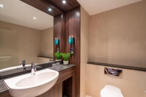 a bathroom with a white sink and a mirror at The Trinity City Hotel in Dublin