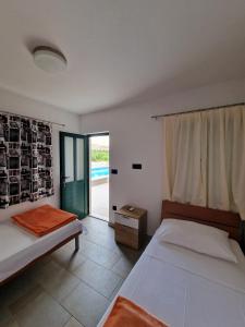 a bedroom with two beds and a view of a pool at Villa Paola in Bol