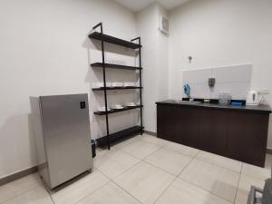 a kitchen with a counter and a refrigerator at HomestayIpoh-Octagon in Ipoh