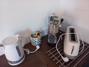a kitchen counter with various appliances on a shelf at Du bonheur et du bon air à Banyuls ! in Banyuls-sur-Mer