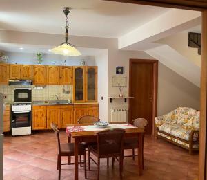 a kitchen with a table and chairs and a couch at Casa Montalbano in Porto Empedocle